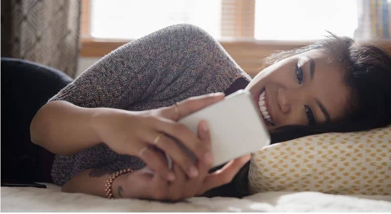 lady texting and smiling